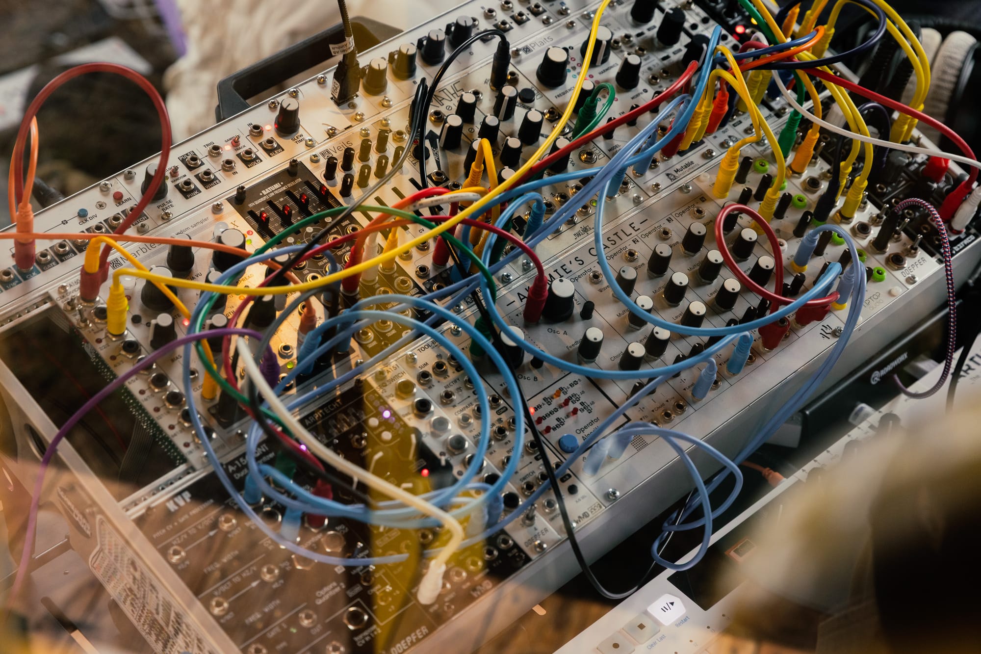 A modular synth set up with multi-coloured patch cables from musician Aoibh.